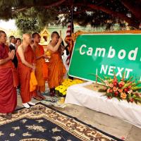 Cambodian monks pray next to new Long Beach Cambodia Town sign 