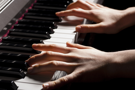 Closeup of hands at a keyboard.