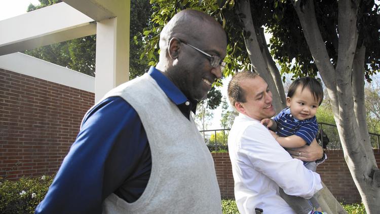 Emmitt Clark, left, Christopher Schivley and Schivley's son, Emmitt. Christoher Schivley was poor, fatherless and desperately seeking guidance when he took a career education class as a freshman at Cal State Long Beach. (Katie Falkenberg / Los Angeles Times)