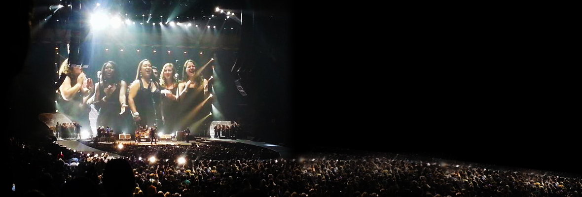 The CSULB Chamber Singers on stage with the Rolling Stones&mdash;long shot over the crowd in the arena.