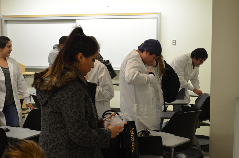 students putting on lab coats