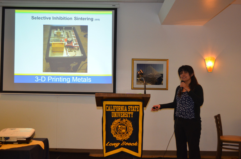 student explaining 3-D printing metals