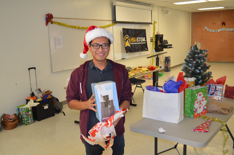 student posing with gift